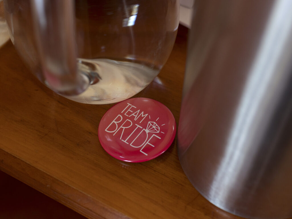 Close up of a pink team Bride badge