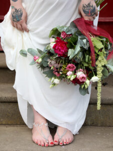 9 month pregnant Bride shows off her fet jewellery and flowers