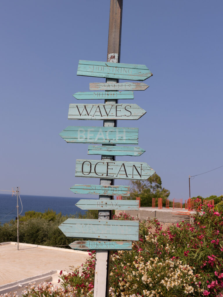 wooden sign for the Zante destination wedding venue. different pieces of wood in different blue tones
